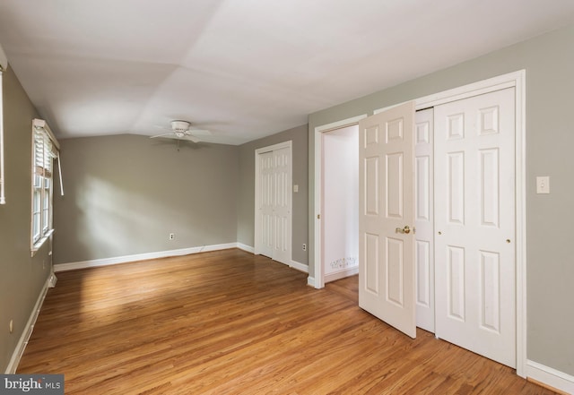 1149 Ollerton Rd, West Deptford, NJ 08066 - unfurnished bedroom featuring multiple closets, light wood finished floors, baseboards, lofted ceiling, and ceiling fan