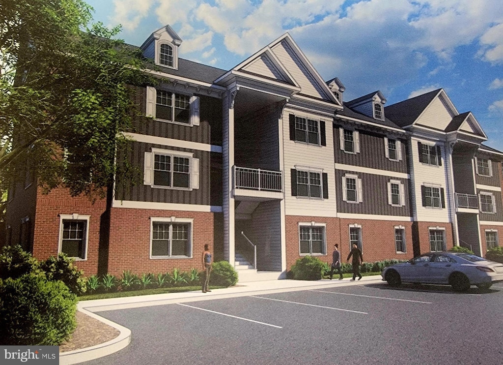 view of property featuring uncovered parking