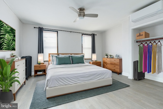 1545 S 19th St, Philadelphia, PA 19146 - bedroom featuring baseboards, light wood-style floors, a wall mounted air conditioner, and ceiling fan
