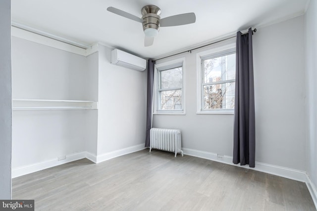 1545 S 19th St, Philadelphia, PA 19146 - unfurnished bedroom with radiator, wood finished floors, baseboards, and a wall unit AC