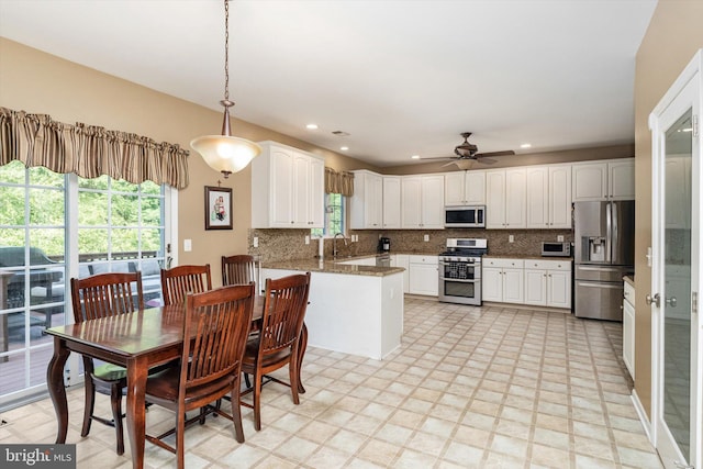 21 Jimarie Ct, Hamilton, NJ 08620 - kitchen featuring stainless steel appliances, a peninsula, decorative backsplash, white cabinets, and recessed lighting