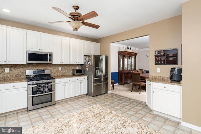 21 Jimarie Ct, Hamilton, NJ 08620 - kitchen with stainless steel appliances, a ceiling fan, white cabinetry, decorative backsplash, and light stone countertops