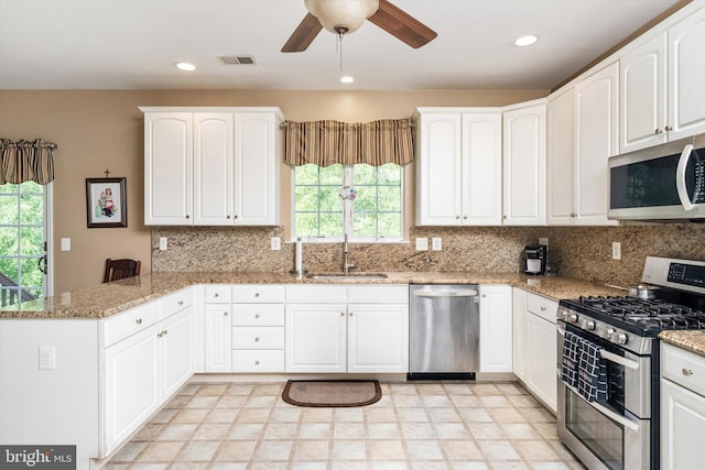 21 Jimarie Ct, Hamilton, NJ 08620 - kitchen featuring stainless steel appliances, a sink, a peninsula, ceiling fan, and white cabinets