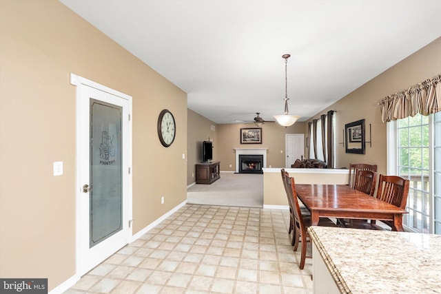 21 Jimarie Ct, Hamilton, NJ 08620 - dining area with a warm lit fireplace, ceiling fan, and baseboards