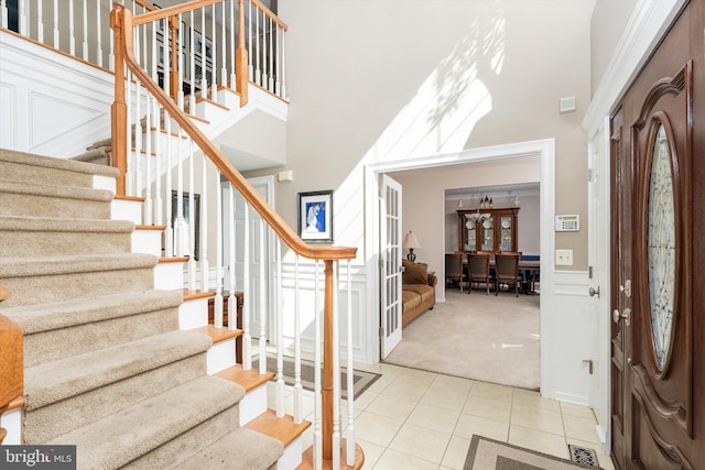 21 Jimarie Ct, Hamilton, NJ 08620 - carpeted entrance foyer with a towering ceiling, stairs, tile patterned flooring, and a decorative wall