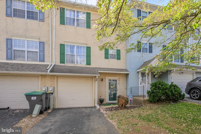view of property with driveway and a garage