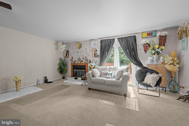 carpeted living room featuring a glass covered fireplace
