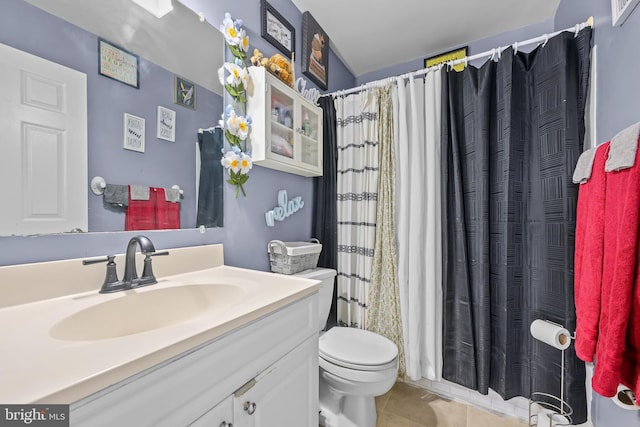 full bathroom featuring curtained shower, vanity, toilet, and tile patterned floors