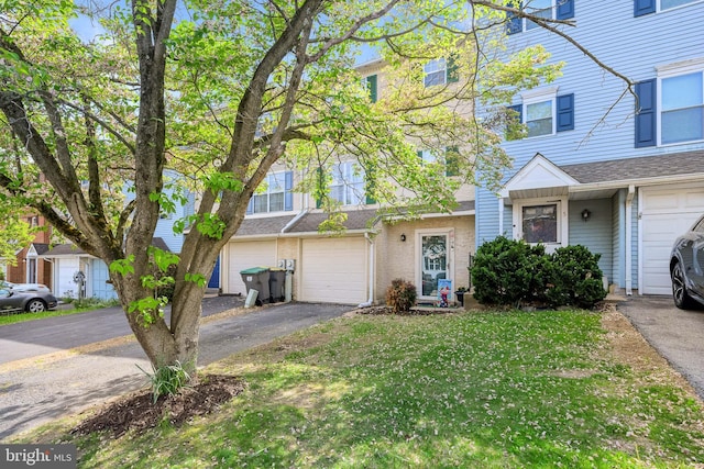 view of property featuring a garage and driveway