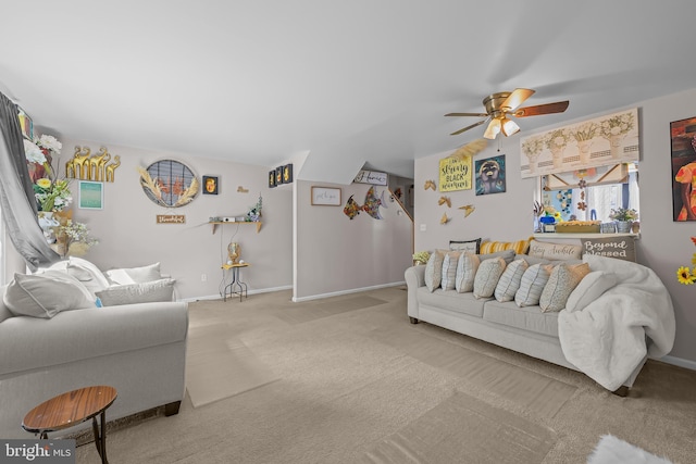living room featuring ceiling fan, carpet flooring, and baseboards