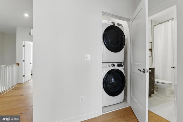 4140 Legato Rd Unit 47, Fairfax, VA 22033 - laundry area with estacked washer and dryer and light wood finished floors