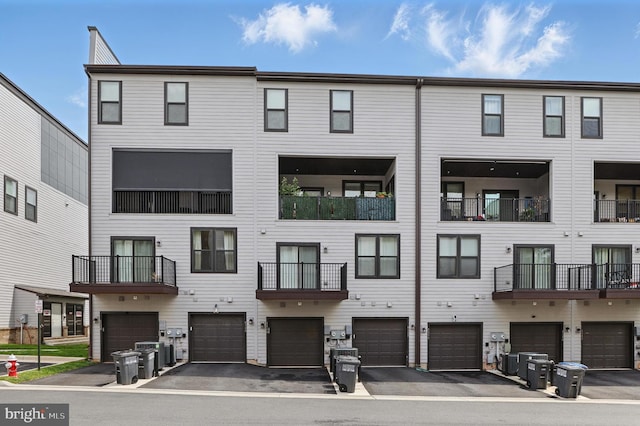 4140 Legato Rd Unit 47, Fairfax, VA 22033 - view of building exterior with an attached garage and driveway