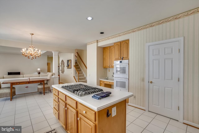 kitchen featuring white double oven, light tile patterned flooring, open floor plan, stainless steel gas cooktop, and wallpapered walls