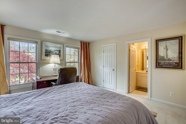 bedroom with carpet flooring, baseboards, and ensuite bathroom