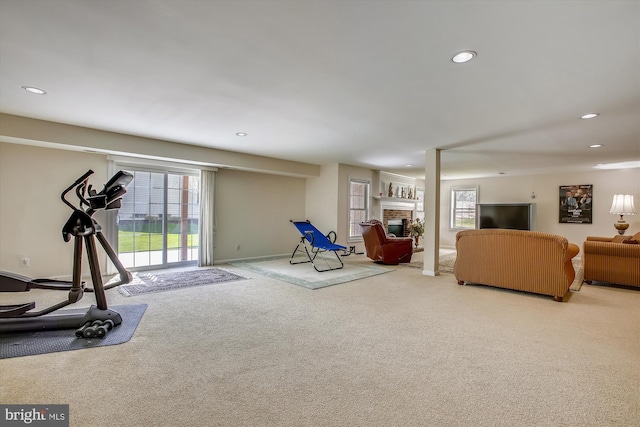 exercise room featuring carpet, recessed lighting, a fireplace, and baseboards