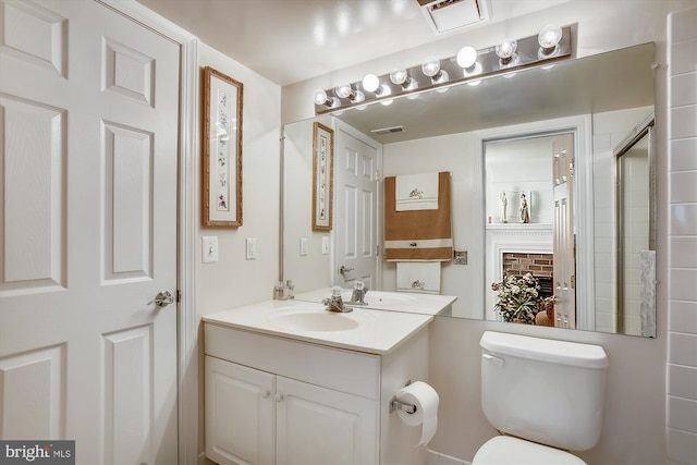 full bath featuring toilet, tiled shower, and vanity
