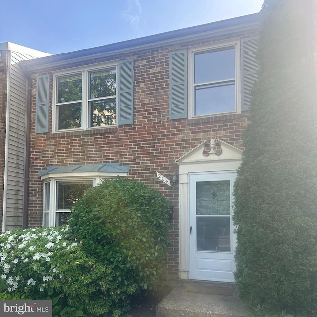 view of side of home featuring brick siding