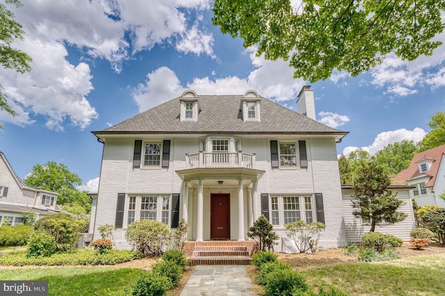 2305 Macdonough Rd, Wilmington, DE 19805 - georgian-style home with a balcony, a chimney, and brick siding