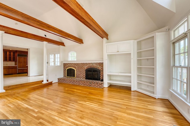 2305 Macdonough Rd, Wilmington, DE 19805 - unfurnished living room with light wood finished floors, ornate columns, and plenty of natural light