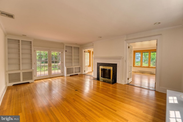 2305 Macdonough Rd, Wilmington, DE 19805 - unfurnished living room with light wood-style flooring, baseboard heating, built in features, crown molding, and plenty of natural light
