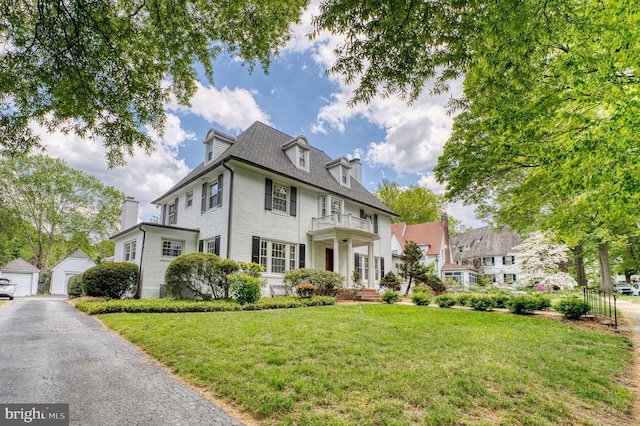 2305 Macdonough Rd, Wilmington, DE 19805 - colonial home featuring a balcony, a front lawn, an outbuilding, and a garage