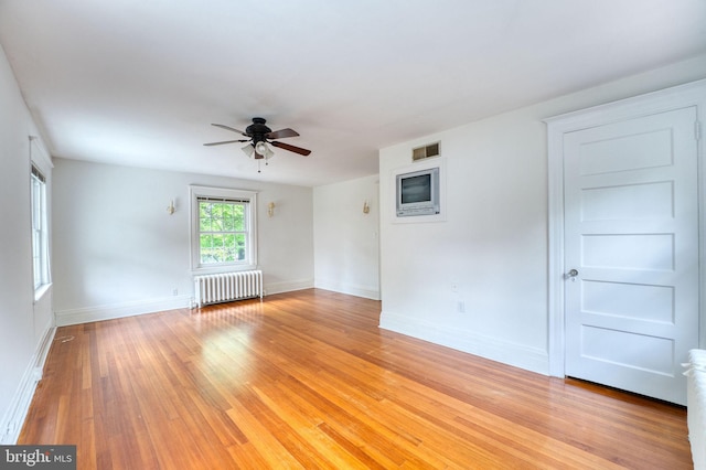 2305 Macdonough Rd, Wilmington, DE 19805 - spare room with radiator heating unit, ceiling fan, light wood-style floors, and baseboards