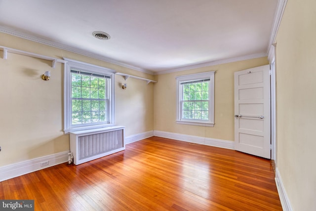 2305 Macdonough Rd, Wilmington, DE 19805 - empty room with radiator, healthy amount of natural light, light wood-type flooring, baseboards, and ornamental molding