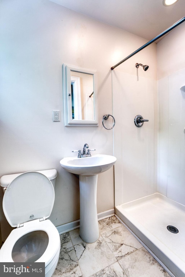 2305 Macdonough Rd, Wilmington, DE 19805 - bathroom featuring a stall shower, marble finish floors, toilet, and baseboards