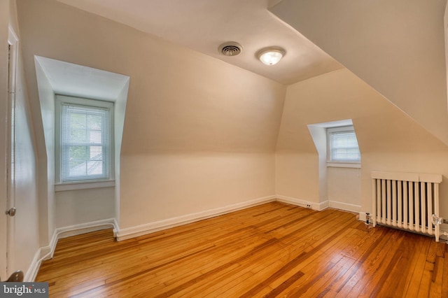 2305 Macdonough Rd, Wilmington, DE 19805 - additional living space with radiator heating unit, hardwood / wood-style floors, baseboards, and vaulted ceiling
