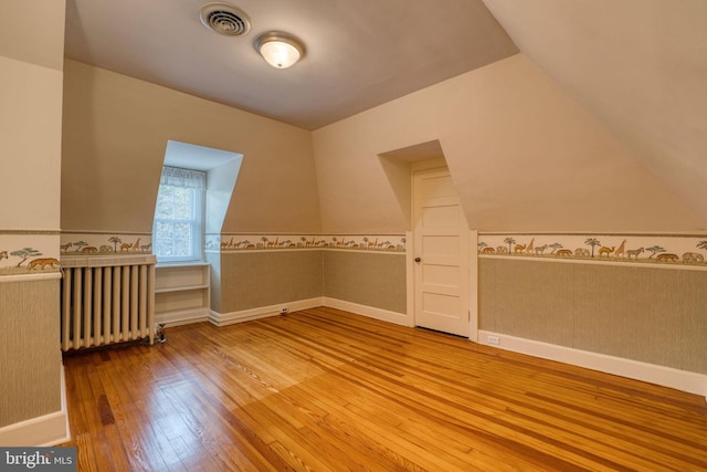 2305 Macdonough Rd, Wilmington, DE 19805 - additional living space featuring radiator heating unit, wood-type flooring, vaulted ceiling, and a wainscoted wall