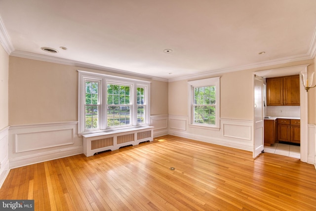 2305 Macdonough Rd, Wilmington, DE 19805 - empty room with radiator, light wood-type flooring, ornamental molding, and wainscoting