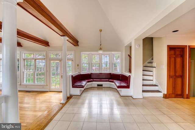 2305 Macdonough Rd, Wilmington, DE 19805 - unfurnished living room with ornate columns, stairway, baseboards, light tile patterned floors, and beamed ceiling