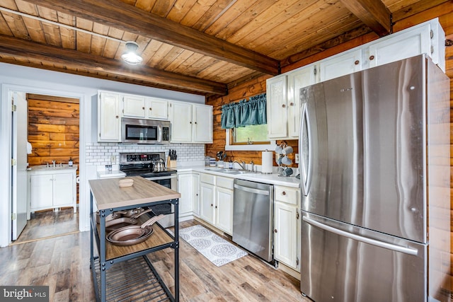 1276 Birch Grove Ln, Berkeley Springs, WV 25411 - kitchen with appliances with stainless steel finishes, wood ceiling, light countertops, white cabinets, and wood finished floors