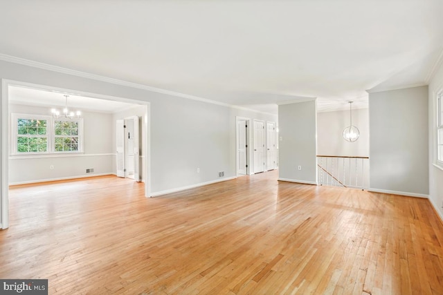 unfurnished living room featuring a chandelier, crown molding, light wood finished floors, and baseboards