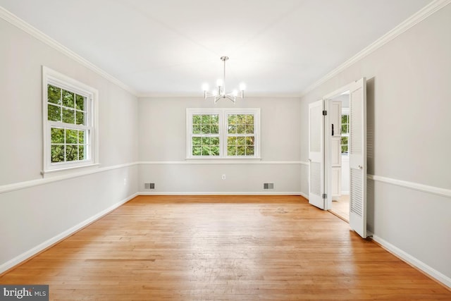 unfurnished dining area with a chandelier, light wood-style flooring, ornamental molding, and baseboards