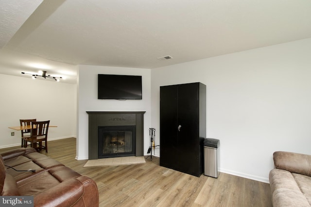 7313 Split Rail Ln, Laurel, MD 20707 - living room featuring light wood-style floors, a fireplace with flush hearth, and baseboards