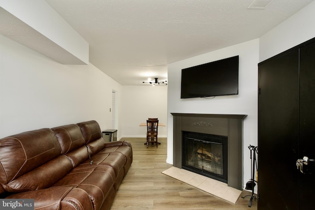 7313 Split Rail Ln, Laurel, MD 20707 - living room with light wood-style flooring, a fireplace with flush hearth, and baseboards