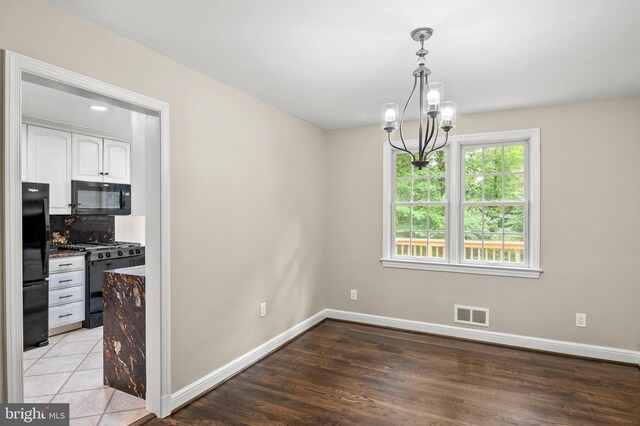 12904 Two Farm Dr, Silver Spring, MD 20904 - unfurnished dining area featuring a chandelier, baseboards, and light wood-type flooring