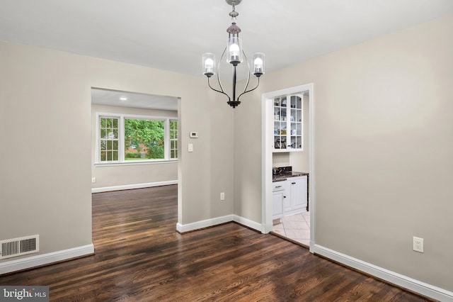 12904 Two Farm Dr, Silver Spring, MD 20904 - unfurnished dining area with baseboards, wood finished floors, and a chandelier