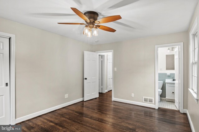 12904 Two Farm Dr, Silver Spring, MD 20904 - unfurnished bedroom with wood finished floors, baseboards, connected bathroom, and a sink