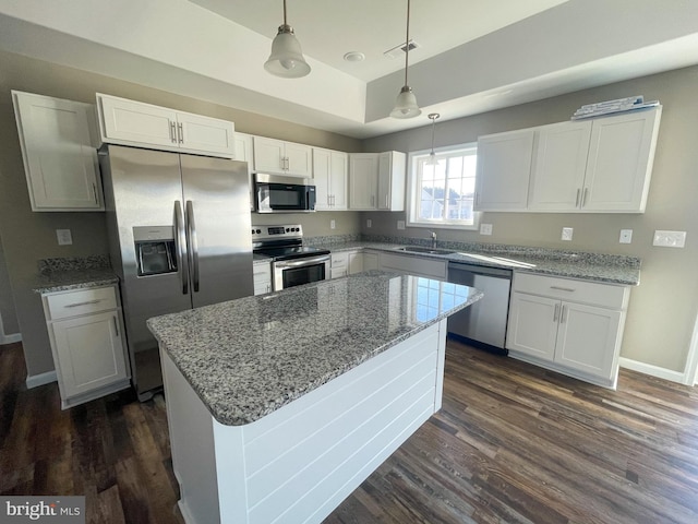 kitchen featuring light stone countertops, a sink, white cabinetry, dark wood-type flooring, and appliances with stainless steel finishes