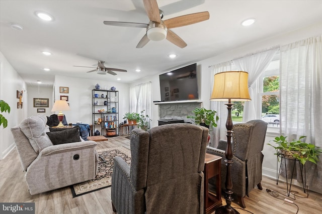 607 Jays Ln, Pottstown, PA 19464 - living room with a ceiling fan, light wood finished floors, a stone fireplace, and recessed lighting