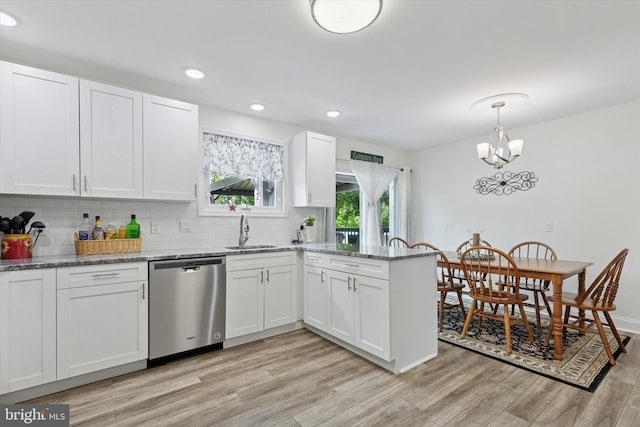 607 Jays Ln, Pottstown, PA 19464 - kitchen with stainless steel dishwasher, a peninsula, light wood finished floors, backsplash, and white cabinetry