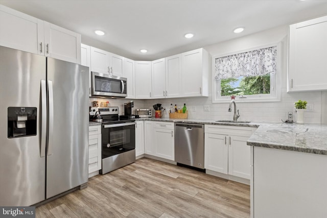 607 Jays Ln, Pottstown, PA 19464 - kitchen with appliances with stainless steel finishes, white cabinetry, light stone counters, light wood finished floors, and recessed lighting