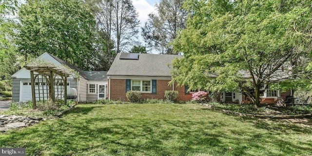 343 Michigan Ave, Swarthmore, PA 19081 - view of front of property featuring a front yard, brick siding, an attached garage, and roof with shingles