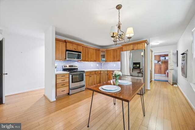 343 Michigan Ave, Swarthmore, PA 19081 - kitchen with appliances with stainless steel finishes, a chandelier, light countertops, decorative backsplash, and decorative light fixtures