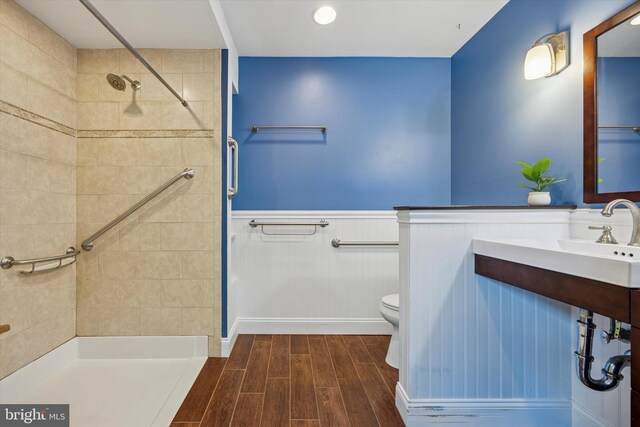 343 Michigan Ave, Swarthmore, PA 19081 - full bathroom with a tile shower, wood finished floors, and wainscoting