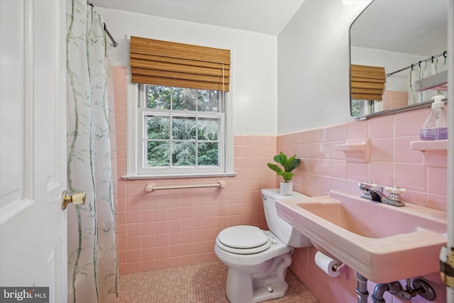 343 Michigan Ave, Swarthmore, PA 19081 - bathroom with tile patterned flooring, a wainscoted wall, tile walls, and a shower with shower curtain