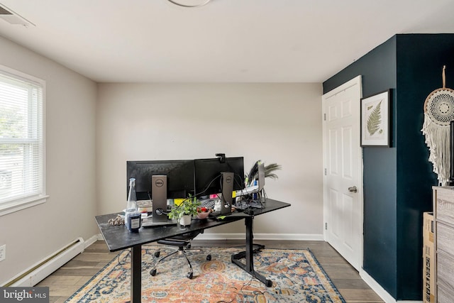 office area featuring a baseboard radiator, wood finished floors, and baseboards