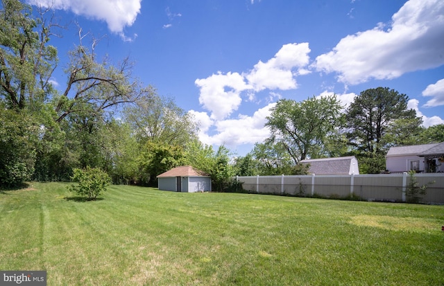 view of yard with a shed, an outdoor structure, and a detached garage